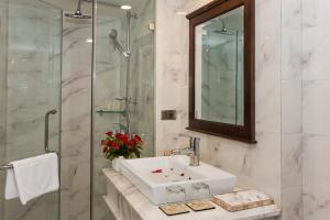 a bathroom with a sink and a glass shower at Hanoi Maro Hotel in Hanoi +53 photos