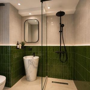 a bathroom with a shower with a toilet and a sink at Matilda Signature Apartments in Telavi +6 photos