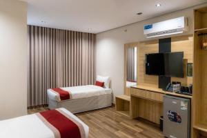 a hotel room with two beds and a flat screen tv at فندق روح المدينة in Medina +114 photos