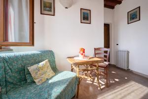 a living room with a couch and a table with a doll on it at Agriturismo Campo Ruffaldo in Massa Marittima