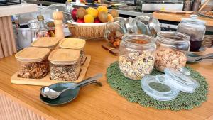 a wooden counter with jars of granola and spoons at Borgo Pascarosa in Ostuni