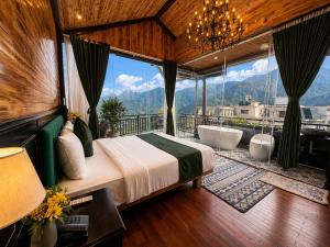 a bedroom with a tub and a bed and a view at Cloud Chaser Hotel in Sapa