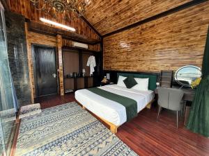 a bedroom with a bed and a desk in a room at Cloud Chaser Hotel in Sapa +58 photos
