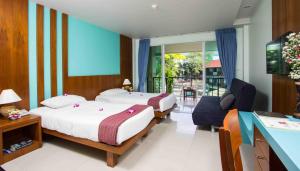 Ein Bett oder Betten in einem Zimmer der Unterkunft Baan Karon Resort
