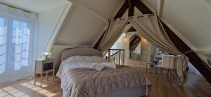 a bedroom with a bed with a canopy at La Romantique du Château in Gaillan-en-Médoc +37 photos