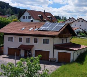 a house with solar panels on the roof at Genusshotel Hohenbogen GARNI in Neukirchen beim Heiligen Blut
