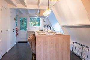 a kitchen with a large island in the middle at Chalet Lupin in Durbuy