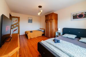 a bedroom with two beds and a dresser at Walter Waves Private Apartment with Balcony and Self Check-In in Costinesti