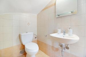 a bathroom with a toilet and a sink at Villa Rita in Spanokhórion +19 photos
