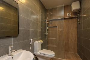 a bathroom with a toilet and a sink and a shower at Hotel Raha Tower in Dar es Salaam +42 photos