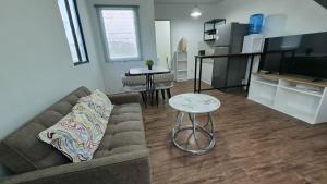 a living room with a couch and a table at Phirst Park Homes Baliwag in Baliuag