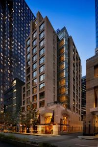 a large building in a city with tall buildings at Hotel Le Soleil by Executive Hotels in Vancouver