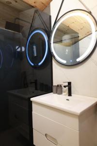 a bathroom with a mirror and a white sink at HRID - vikendica u prirodi in Šavnik +25 photos