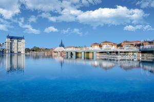 a large body of water with a bridge and buildings at Granada Luxury Belek - Family Kids Concept in Belek