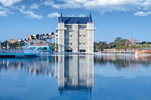 a large white building sitting on top of a body of water at Granada Luxury Belek - Family Kids Concept in Belek +290 photos