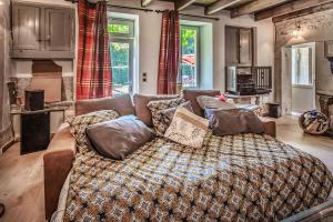a living room with a couch with pillows on it at La Grange des zarts in Champagné-le-Sec