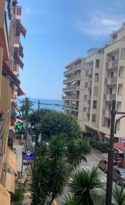a city street with palm trees and tall buildings at Blue Riviera in Roquebrune-Cap-Martin