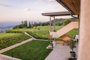 a patio with a view of a hill with horses in the background at Gut Herzogberg in Sonntagberg