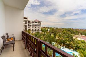 a balcony with a view of a resort at Malika Blue Hotel Nungwi, Zanzibar in Banda Kuu