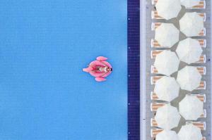 an overhead view of a woman in a swimming pool at Greenwood Suites Resort in Lara