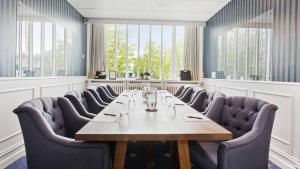 a conference room with a long table and chairs at Marienlyst Strandhotel in Helsingør +42 photos