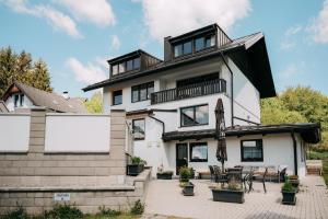 a white house with a black roof at Apartment Slupečná Lipno in Kramolín
