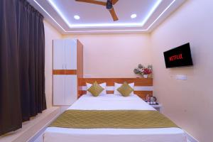 a bedroom with a bed and a tv on the ceiling at I&S Residency in Rāmanāthapuram +3 photos