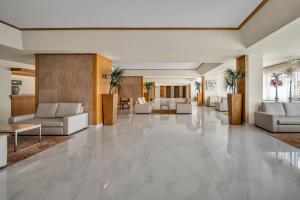 a lobby with couches and tables and a lobby at Albufeira Sol Hotel & Spa in Albufeira