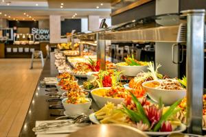 a buffet line with many plates of food at Albufeira Sol Hotel & Spa in Albufeira
