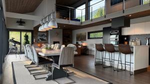 a kitchen and dining room with a table and chairs at Bergnes Lodge in Senja