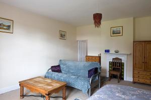 a living room with a couch and a table at Monument View in Hexham
