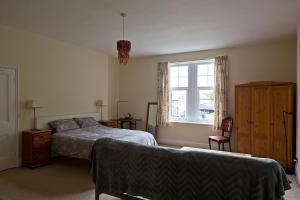 a bedroom with a bed and a window at Monument View in Hexham