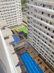 an aerial view of two tall buildings and a swimming pool at Cozy Studio for 4 Guests in Dasmariñas