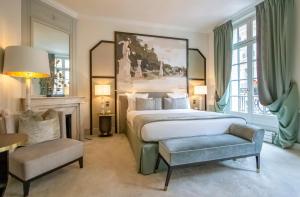a bedroom with a large bed and a chair at Hôtel Elysia by Inwood Hotels in Paris +60 photos