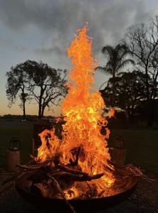 a fire is burning in a fire pit at Copper Creek Retreat - sleep next door to the Lions in Lovedale