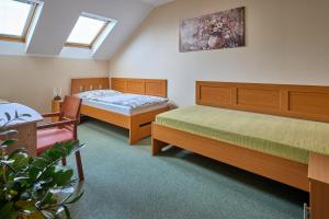a bedroom with two beds and a plant at Penzion Aida Ostrava in Ostrava +61 photos