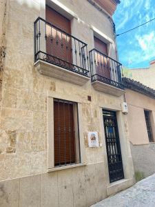 a building with two balconies and a door at casa muralla - plaza mayor in Ciudad-Rodrigo