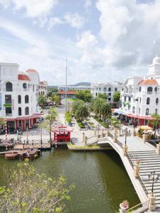 a bridge over a river in a city with buildings at Thiên Ý Homestay in Phú Quốc