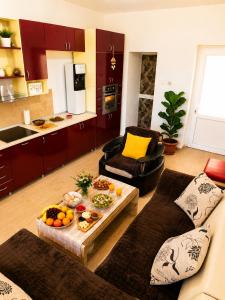 a living room with a couch and a table with food on it at Hana Skadar Lake - 200 metara do jezera in Prevlaka