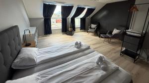 a bedroom with two beds and a living room at Bodø Hotel in Bodø