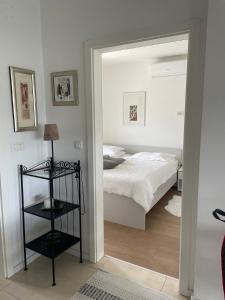 a bedroom with a bed and a mirror at Apartma LAVANDA 3 Šilo in Šilo +11 photos