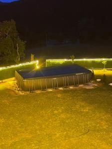 a trampoline in a park at night with lights at Vulovica konak in Bajina Bašta