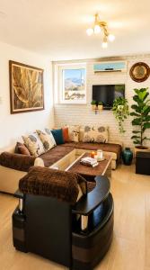 a living room with a couch and a table at Hana Skadar Lake - 200 metara do jezera in Prevlaka