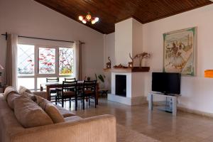 a living room with a couch and a dining room at Somptua Garden Boutique Hôtel in Ivato