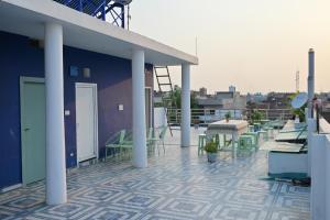 a patio with tables and chairs on a roof at shangrila stay in Bodh Gaya