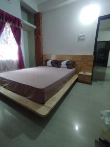 a bedroom with a large bed in a room at Phalchaa Stay in Jaigaon