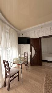 a dining room with a glass table and chairs at Motel in Sarny