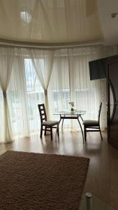 a dining room with a table and two chairs and a table at Motel in Sarny