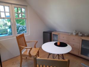 a kitchen with a table and two chairs and a table at Männi hoovimaja in Pärnu +9 photos