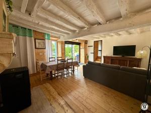 a living room with a couch and a table at Le gîte des oiseaux in Aisy-sous-Thil